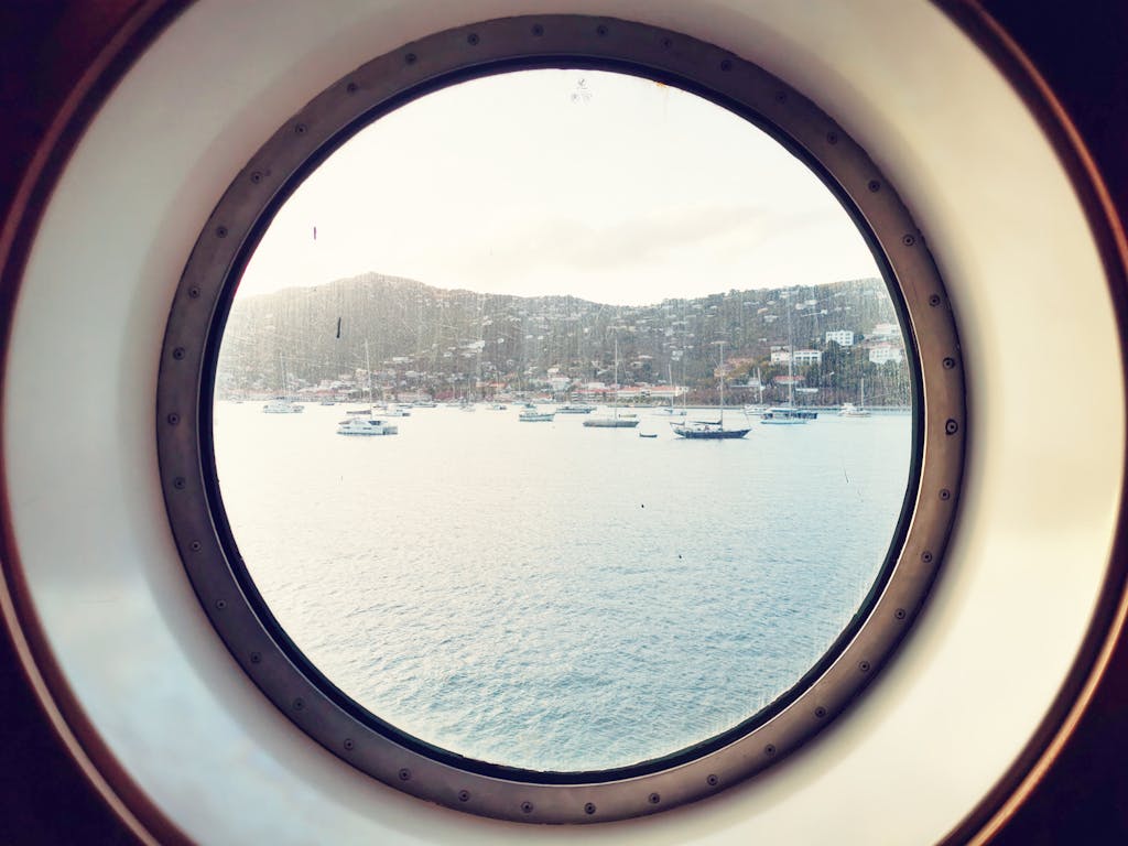 Yachts and Sea Coast behind Ship Window